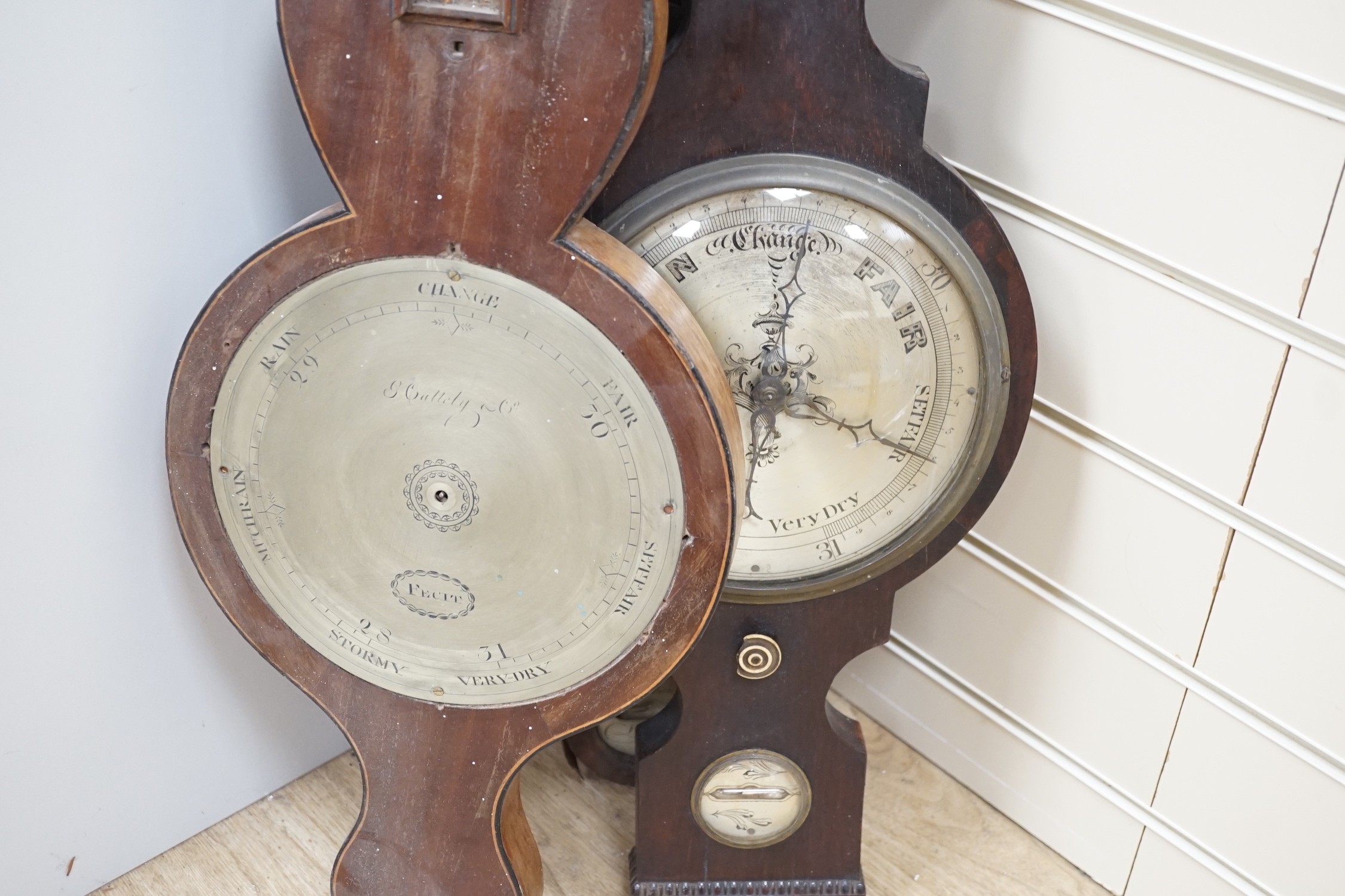 A 19th century bracket timepiece movement, a pair of iron clock weights and three barometer carcasses